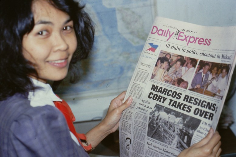 Helen Saldana holds newspaper headline