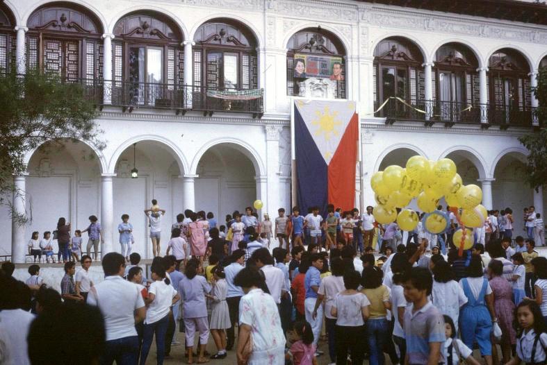 Crowds throng Malacanang Palace following departure of the Marcos family
